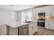 Modern kitchen featuring quartz countertops, stainless steel appliances, and ample cabinet space at 21248 N 58Th St, Phoenix, AZ 85054