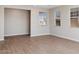 Neutral-toned living area featuring wood-look tile floors and bright windows at 21248 N 58Th St, Phoenix, AZ 85054