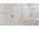 White shower with glass partition, rain style shower head, built in niche, and a small window at 21248 N 58Th St, Phoenix, AZ 85054