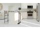 Modern kitchen with stainless steel appliances, white cabinetry, and a sleek island with seating at 24863 N 167Th Dr, Surprise, AZ 85387