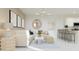 Inviting living area open to kitchen with white sofa, art decor and modern lighting at 24863 N 167Th Dr, Surprise, AZ 85387