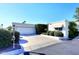 Charming single-story home features a clean white facade, manicured landscaping, and a convenient two-car garage at 25 E San Miguel E Ave, Phoenix, AZ 85012