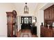 Elegant foyer with hardwood floors, a striking black door, and classic furnishings, creating a warm welcome at 25 E San Miguel E Ave, Phoenix, AZ 85012