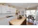 Bright kitchen featuring white cabinetry, butcher block island, and breakfast nook at 25 E San Miguel E Ave, Phoenix, AZ 85012