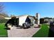 A tranquil patio setting with outdoor dining, manicured lawn, and a covered patio area at 25 E San Miguel E Ave, Phoenix, AZ 85012