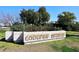 Coulter Estates entrance sign surrounded by mature trees and greenery, showcasing community pride at 25 E San Miguel E Ave, Phoenix, AZ 85012