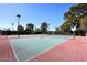 Well-maintained tennis court under a bright blue sky, promising endless hours of active enjoyment at 25 E San Miguel E Ave, Phoenix, AZ 85012