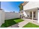 Private backyard featuring synthetic grass, desert landscaping, and a small seating area at 2828 E Waltann Ln # 1, Phoenix, AZ 85032