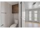 Bright bathroom offering a toilet, and access to the kitchen and the patio at 2828 E Waltann Ln # 1, Phoenix, AZ 85032