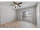 Bright bedroom with wood-look floors, ceiling fan, and sliding glass door to balcony at 2828 E Waltann Ln # 1, Phoenix, AZ 85032