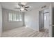 This bedroom features neutral walls, modern light wood flooring, and a window with white shutters at 2828 E Waltann Ln # 1, Phoenix, AZ 85032