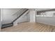 Spacious living room featuring wood-look flooring and a staircase leading to upper level at 2828 E Waltann Ln # 1, Phoenix, AZ 85032