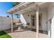 Relax in this covered patio, featuring classic brick flooring and bright white stucco walls at 2828 E Waltann Ln # 1, Phoenix, AZ 85032