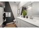 Modern bathroom featuring a double vanity, geometric accent wall, and stylish fixtures at 2843 W Eagle Talon Rd, Phoenix, AZ 85085