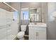 Bright bathroom with a glass-enclosed shower, white vanity, and a view from the window at 2843 W Eagle Talon Rd, Phoenix, AZ 85085