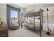 Cozy bedroom featuring a bunk bed, bean bag chair, and a large window with city views at 2843 W Eagle Talon Rd, Phoenix, AZ 85085