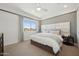 Comfortable bedroom with a large window, plush bedding, and sophisticated decor at 2843 W Eagle Talon Rd, Phoenix, AZ 85085