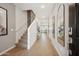 Inviting entryway with wood-look tile, staircase, and decorative mirror at 2843 W Eagle Talon Rd, Phoenix, AZ 85085