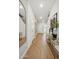 Bright hallway with wood flooring, art, large mirror and a view of the front door at 2843 W Eagle Talon Rd, Phoenix, AZ 85085