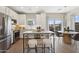 Bright eat-in kitchen featuring white cabinets, island seating, and stainless appliances at 2843 W Eagle Talon Rd, Phoenix, AZ 85085