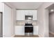 Kitchen featuring stainless steel appliances and white cabinetry at 3331 E Mckinley St, Phoenix, AZ 85008