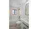 Bathroom features a shower-tub combo, white vanity, and updated fixtures for a modern touch at 3417 E Lupine Ave, Phoenix, AZ 85028
