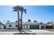 Charming single-story home featuring a two-car garage, desert landscaping, and tall palm trees at 3417 E Lupine Ave, Phoenix, AZ 85028