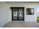 A covered patio featuring black framed french doors and a black-framed window at 3417 E Lupine Ave, Phoenix, AZ 85028