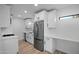 Bright kitchen featuring white cabinets, quartz countertops, stainless steel appliances and sleek flooring at 3417 E Lupine Ave, Phoenix, AZ 85028