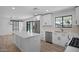 Modern kitchen with white cabinets, quartz countertops, stainless steel appliances, and a view to the pool at 3417 E Lupine Ave, Phoenix, AZ 85028