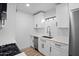 Well-lit kitchen showcasing bright white cabinets, sleek countertops, and stainless steel appliances at 3417 E Lupine Ave, Phoenix, AZ 85028