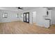 Open-concept living space featuring modern flooring, French doors to yard and a glimpse of the adjacent kitchen at 3417 E Lupine Ave, Phoenix, AZ 85028