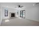 Bright living room with fireplace, neutral carpet, and glass sliding doors to pool area at 3417 E Lupine Ave, Phoenix, AZ 85028