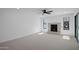 Open living space features a stone fireplace, neutral carpeting, and natural light with access to the outdoors at 3417 E Lupine Ave, Phoenix, AZ 85028