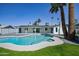 A refreshing backyard pool is surrounded by a green lawn and desert landscaping, creating an oasis at 3417 E Lupine Ave, Phoenix, AZ 85028