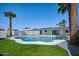 Backyard pool featuring an inviting pool with blue water and a manicured lawn, perfect for outdoor relaxation at 3417 E Lupine Ave, Phoenix, AZ 85028
