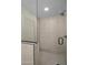 Walk-in shower with beige tiling, glass door and black hardware at 3417 E Lupine Ave, Phoenix, AZ 85028