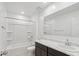 Bathroom features a shower-tub combo, dark vanity, and ample counter space at 35474 N Breezy Ln, San Tan Valley, AZ 85140