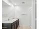 Bright bathroom featuring double sinks, a marble countertop, and a walk-in shower at 35474 N Breezy Ln, San Tan Valley, AZ 85140