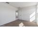 This bedroom features bright light, carpeted floors, and a view of the hall at 35474 N Breezy Ln, San Tan Valley, AZ 85140