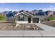 Charming single-story home showcasing desert landscaping, a modern design, and stunning mountain views in the background at 35474 N Breezy Ln, San Tan Valley, AZ 85140