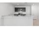 Kitchen with dark cabinetry, stainless steel microwave and oven, as well as marble countertops and a breakfast bar at 35474 N Breezy Ln, San Tan Valley, AZ 85140