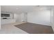 Open-concept living space with carpet, tile flooring, and a view into the modern kitchen area at 35474 N Breezy Ln, San Tan Valley, AZ 85140
