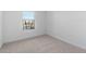 Bright, minimalist bedroom with soft carpeting and a single window at 3841 S 233Rd Ln, Buckeye, AZ 85326