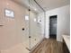 Modern bathroom featuring a frameless glass shower with white tiles and sleek black hardware at 40165 N Alameda Dr, San Tan Valley, AZ 85140