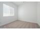 Cozy bedroom with large window providing ample natural light, plush carpet, and white walls at 40165 N Alameda Dr, San Tan Valley, AZ 85140