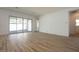 Spacious living area with wood look ceramic tile flooring and sliding glass doors at 40165 N Alameda Dr, San Tan Valley, AZ 85140