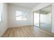 Bright living room with wood-look tile flooring and sliding glass doors to the outdoors at 40165 N Alameda Dr, San Tan Valley, AZ 85140