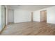 Spacious living area with wood look ceramic tile flooring, sliding glass doors and white walls at 40165 N Alameda Dr, San Tan Valley, AZ 85140