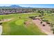 Breathtaking aerial shot of the lush golf course featuring the pristine green grasses and scenic desert landscape at 4214 E Donato Dr, Gilbert, AZ 85298